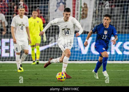 Serbia midfielder Nikola Petković (14) gets past United States of America forward Alex Zendejas (17) during an international friendly match, Wednesday Stock Photo