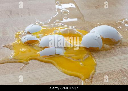Horizontal shot of a shattered chicken egg on the floor. Stock Photo