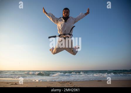 Gaza, Palestine. 26th Jan, 2023. Palestinian youth practices taekwondo on the Mediterranean beach during sunset in Khan Yunis, southern Gaza Strip. (Photo by Yousef Masoud/SOPA Images/Sipa USA) Credit: Sipa USA/Alamy Live News Stock Photo