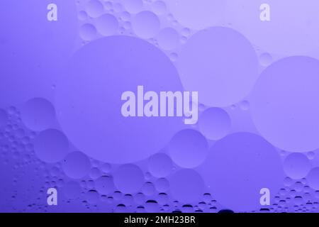Oil bubbles on the water with Purple background, for cosmetic liquid beauty product. Face serum background Stock Photo