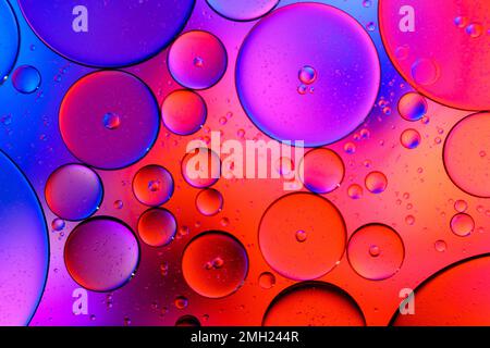 Red and Purple Colorful artistic of oil on the water. Abstract Colorful Oil bubbles For background. holiday light  postcard Stock Photo