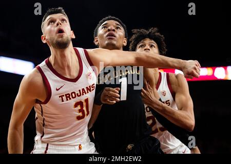 Colorado guard Tyler Bey, center, loses control of the ball after UC Irvine  guard Evan Leonard, right, attempted a steal as UC Irvine forward Tommy  Rutherford covers in the first half of