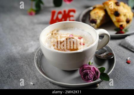 Valentines day breakfast Cappuccino heart  served with scones Stock Photo