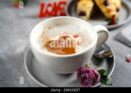 Valentines day breakfast Cappuccino heart  served with scones Stock Photo