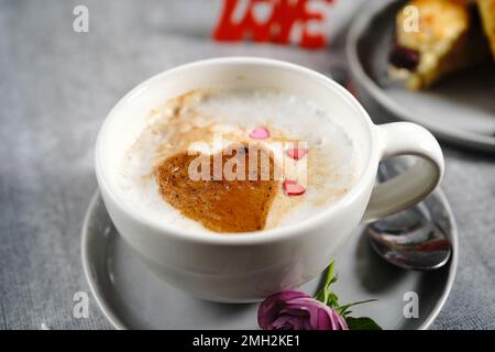 Valentines day breakfast Cappuccino heart  served with scones Stock Photo
