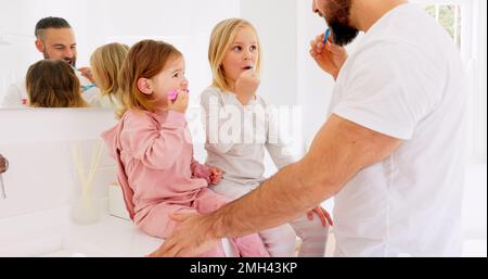 Brushing teeth, family and bathroom by children learning, cleaning and grooming with father in morning. Happy family, teaching and kids with parent Stock Photo