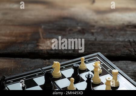 chess stand on an old black wooden table, chess game, chess pieces Stock Photo