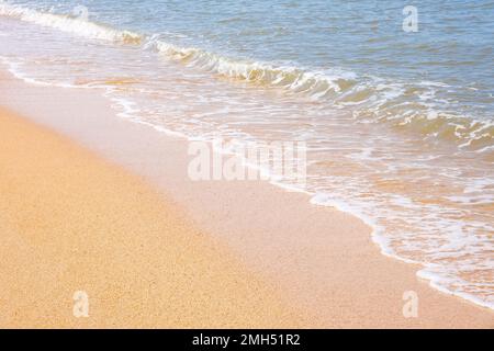 The coast of the Sea of Azov. Sea waves roll on the sandy shore. Seashell sandy beach. Stock Photo