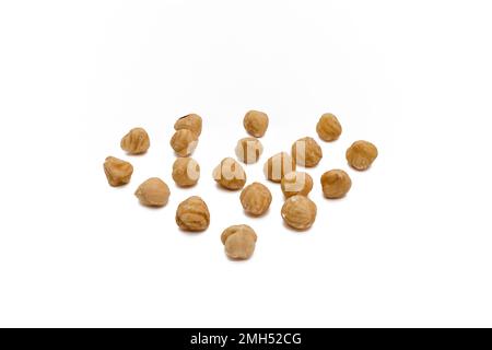 hazelnuts arranged in triangle. hazelnut isolated on a white background. Full depth of field. close up Stock Photo