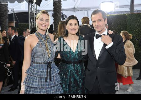 Actors, from left, Margot Robbie and Christoph Waltz, react as