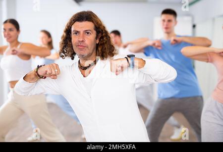 Group of smiling people of different ages dancing and practicing new movements in class. Sport, dance and urban culture concept Stock Photo
