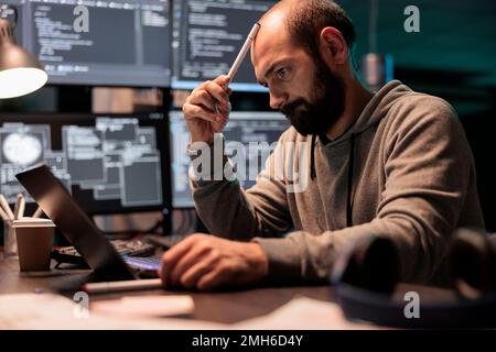 Pensive coder brainstorming ideas to find source code and develop html script on terminal window. Thinking about solution to create cloud computing server interface, coding program. Stock Photo