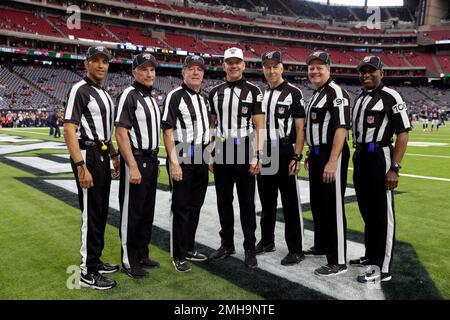 Officials, from left to right, replay official Kevin Brown, down judge  Michael Dolce, field judge Jimmy Buchanan, umpire Bryan Neale, referee  Shawn Smith, back judge Dino Paganelli, line judge Mark Steinkerchner and