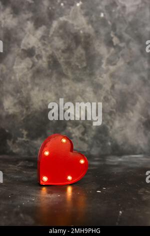 Red lighted heart on a black bacground. Copy space Stock Photo