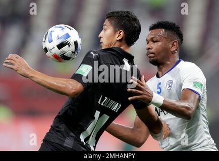 Al Hilal's Ali Al Bulayhi, right, fights for the ball with Urawa