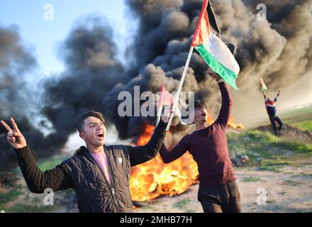 Gaza, Palestine. 26th Jan, 2023. Palestinians chant slogans during the clashes with Israeli forces, near the Israel-Gaza border east of Gaza City. The Palestinian factions organized a protest on the border between Israel and Gaza strip to express their rage against what happened in Jenin. At least nine Palestinians were killed, including an elderly woman, during the clashes in Jenin on 26 January, according to the Palestinian Health Ministry. Israeli security forces said they conducted a 'counterterrorism operation' in the center of Jenin. Credit: SOPA Images Limited/Alamy Live News Stock Photo