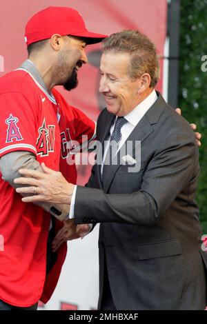 The Los Angeles Angels owner, Arte Moreno gives outfielder, Josh Hamilton  his jersey and hat in a press conference at ESPN Zone at Downtown Disney in  Anaheim, California on December 15, 2012.