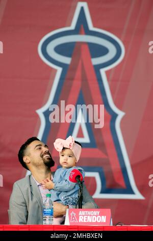 Anthony Rendon looks over with his daughter, Emma, during a news conference  to introduce Rendon as the newest Los Angeles Angels baseball player in  Anaheim, Calif., Saturday, Dec. 14, 2019. Rendon and