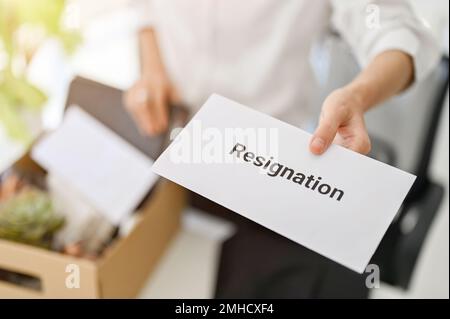 close-up image of a businesswoman sending a resignation letter. unemployment, resignation, career failure, leaving job, changing a job for better posi Stock Photo