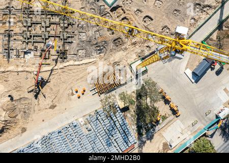construction site view from above. working concrete pumping machine and crane. stacked construction materials. aerial photo. Stock Photo