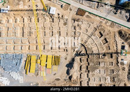aerial view of construction site. earthworks and building foundation. stacked construction materials. Stock Photo