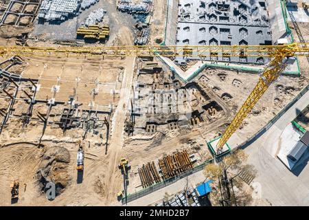 busy construction site. construction equipment and materials, cranes work. aerial top view. Stock Photo