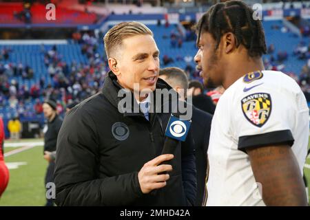 CBS sideline reporter Evan Washburn, right center, interviews