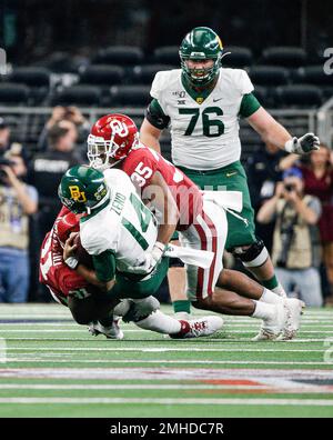 Oklahoma defensive tackle Jalen Redmond (31), defensive lineman Neville  Gallimore (90) and linebacker Nik Bonitto (35) celebrate Redmond's sack of  Baylor quarterback Gerry Bohanon during the second half of an NCAA college