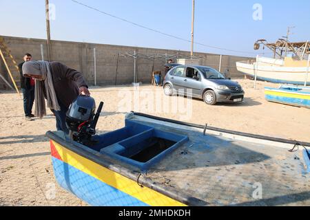 Gaza, Palestine. 26th Jan, 2023. A Palestinian fisherman Zeiad Al-Najar 68, checks his new engine which is installed on his fishing boat at the Gaza seaport in Gaza City. In the last week, permitted the import of 12 outboard engines, said the United Nations. Israel had previously barred their entry based on concern they could prove 'dual use'. The repairs are taking place at an U.N.-supervised workshop on the beach, near the so-called 'Boat Graveyard' where dozens of rusty vessels have been piled up, abandoned after breakdowns. Credit: SOPA Images Limited/Alamy Live News Stock Photo