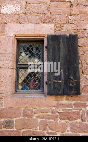 old window with shutters in a brick wall Stock Photo