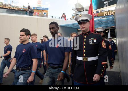 U.S. Military recruits are sworn in during halftime on Salute to Service  military appreciation day at an NFL football game between the Jacksonville  Jaguars and the Las Vegas Raiders, Sunday, Nov. 6