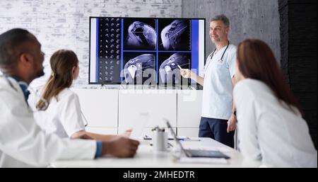 Physician Doctors Looking At Shoulder MRT Scan Stock Photo