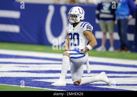 Indianapolis Colts running back Jordan Wilkins (20) runs through an opening  in the line during an NFL football game against the Carolina Panthers,  Sunday, Aug. 15, 2021, in Indianapolis. (AP Photo/Zach Bolinger