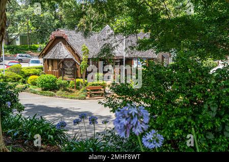 Clock Shop surrounded by trees in main street of Maleny, Sunshine Coast Hinterland, Queensland Australia Stock Photo
