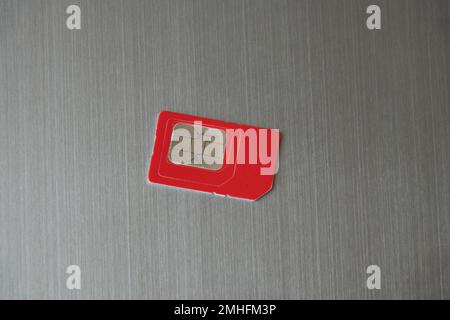 sim card lies on a gray steel background Stock Photo