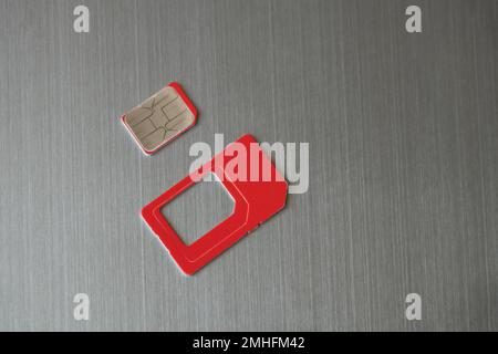 sim card lies on a gray steel background Stock Photo