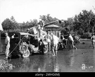 On set location candid with Movie Crew including Cinematographer JAMES WONG HOWE (seated in carriage with white cap) during filming of THE EAGLE AND THE HAWK 1950 director LEWIS R. FOSTER Pine - Thomas Productions / Paramount Pictures Stock Photo