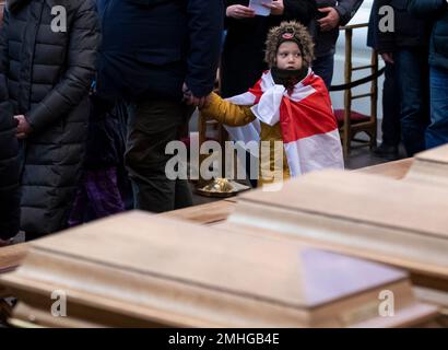 Visitors pay their respects at the caskets of commanders Zygmunt Sierakowski and Konstanty Kalinowski and 18 other participants of the 1863-1864 uprising is carried through Cathedral Basilica of St. Stanislaus and St. Ladislaus during the state funeral ceremony in Vilnius, Lithuania, Friday, Nov. 22, 2019. Unearthed mass burials of the participants of the 1863 uprising discovered almost three years ago on the Gediminas Hill in Vilnius. (AP Photo/Mindaugas Kulbis)