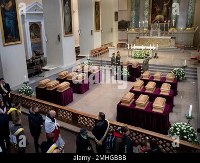 Visitors pay their respects at the caskets of commanders Zygmunt Sierakowski and Konstanty Kalinowski and 18 other participants of the 1863-1864 uprising at the Cathedral Basilica of St. Stanislaus and St. Ladislaus during the state funeral ceremony in Vilnius, Lithuania, Friday, Nov. 22, 2019. Unearthed mass burials of the participants of the 1863 uprising were discovered almost three years ago on the Gediminas Hill in Vilnius. (AP Photo/Mindaugas Kulbis)