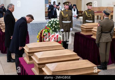 Polish President Andrzej Duda, second left, and Lithuanian President Gitanas Nauseda at the Cathedral Basilica of St Stanislaus and St Ladislaus to pay their respects to commanders Zygmunt Sierakowski and Konstanty Kalinowski and 18 other participants of the 1863-1864 uprising during the state funeral in Vilnius, Lithuania, Friday, Nov. 22, 2019. Unearthed mass burials of the participants of the 1863 uprising were discovered almost three years ago on the Gediminas Hill in Vilnius. (AP Photo/Mindaugas Kulbis)