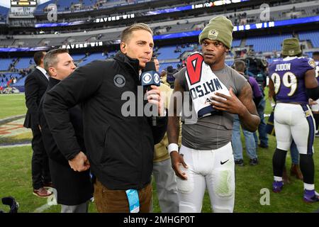 CBS sports reporter Evan Washburn, left, stands next to Baltimore