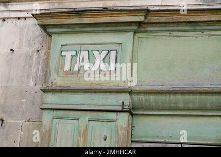 old vintage taxi sign on wooden office agency of cab driver Stock Photo