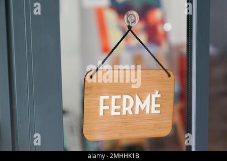 fermé means in french closed boutique on wooden sign board wood on windows shop restaurant cafe store signboard Stock Photo