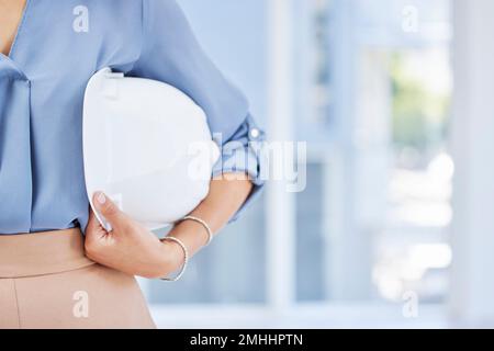 Woman, hands and helmet for construction safety, building or contractor ready for a job on site at office. Hand of female employee engineer or builder Stock Photo