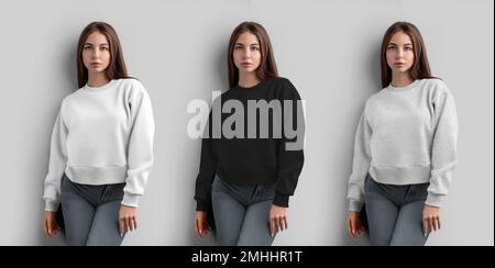 Mockup of a white, black, heather crop sweatshirt on a girl, women's shirt for design, isolated on a wall background, front view. Fashion casual cloth Stock Photo