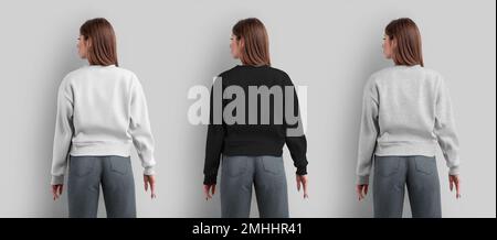 Mockup of a female sweatshirt, white, black, heather crop shirt on a slender girl in gray jeans, back view, for design, print. Blank apparel template, Stock Photo