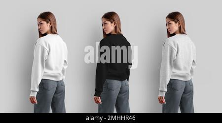 Mockup of a female sweatshirt, white, black, heather crop shirt on a girl in jeans, back view, isolated on background. Blank apparel template for desi Stock Photo