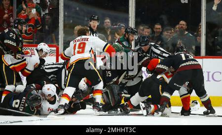 Arizona Coyotes defenseman Josh Brown (3) lands a punch during a fight  against San Jose Sharks center Michael Eyssimont as linesman Devin Berg,  left, looks on during the first period of an