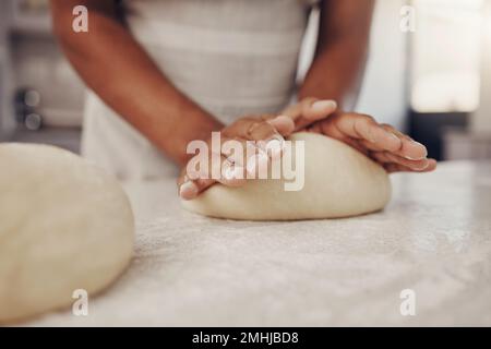 Man hands and dough press in kitchen for baking preparation work and process at culinary counter. Restaurant chef and worker in professional kitchen Stock Photo