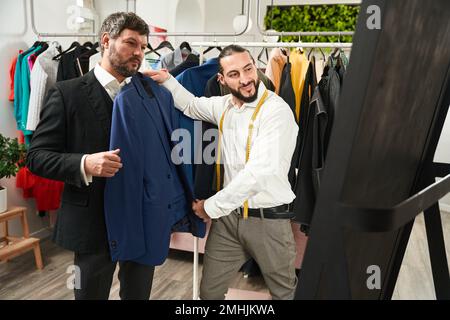 Stylist working with client in his studio Stock Photo